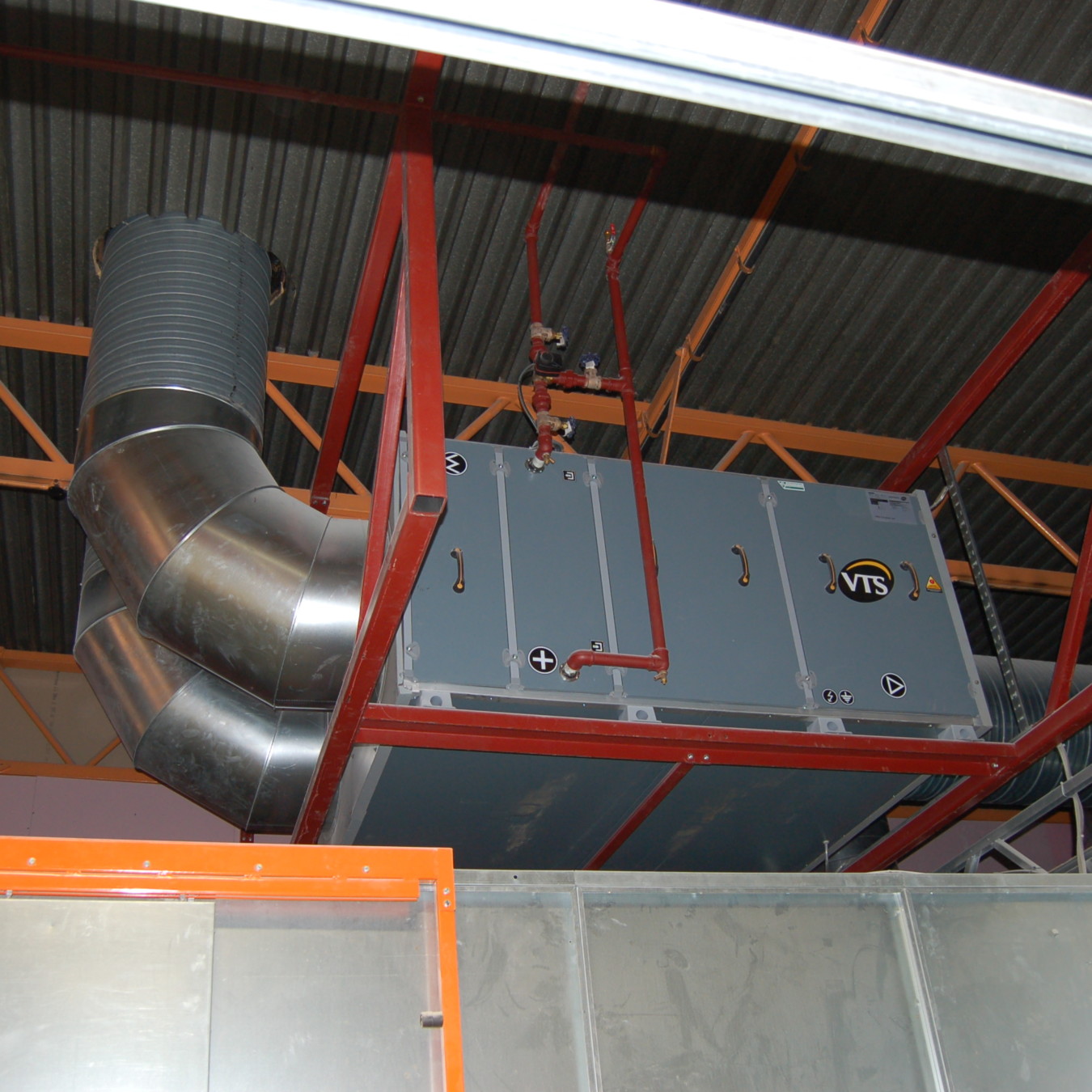 Air handling unit feeding heated make-up air into a paint line from outside.